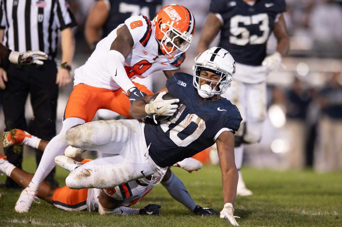 Penn State Nittany Lions running back Nicholas Singleton is tackled to the ground during the football game against Illinois at Beaver Stadium on Saturday, Sept. 28, 2024. The Nittany Lions won 21-7.