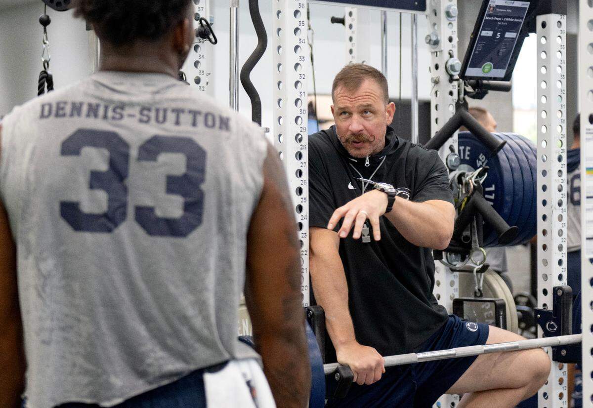 Penn State assistant AD for performance enhancement Chuck Losey talks with defensive end Dani Dennis-Sutton during a summer strength session on Monday, July 14, 2025 in the Lasch Building.