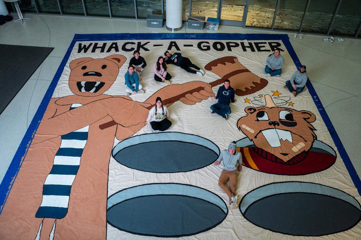 The Roar Zone designed and painted this 30 x 30 banner for the wear white game against Minnesota on Feb. 28