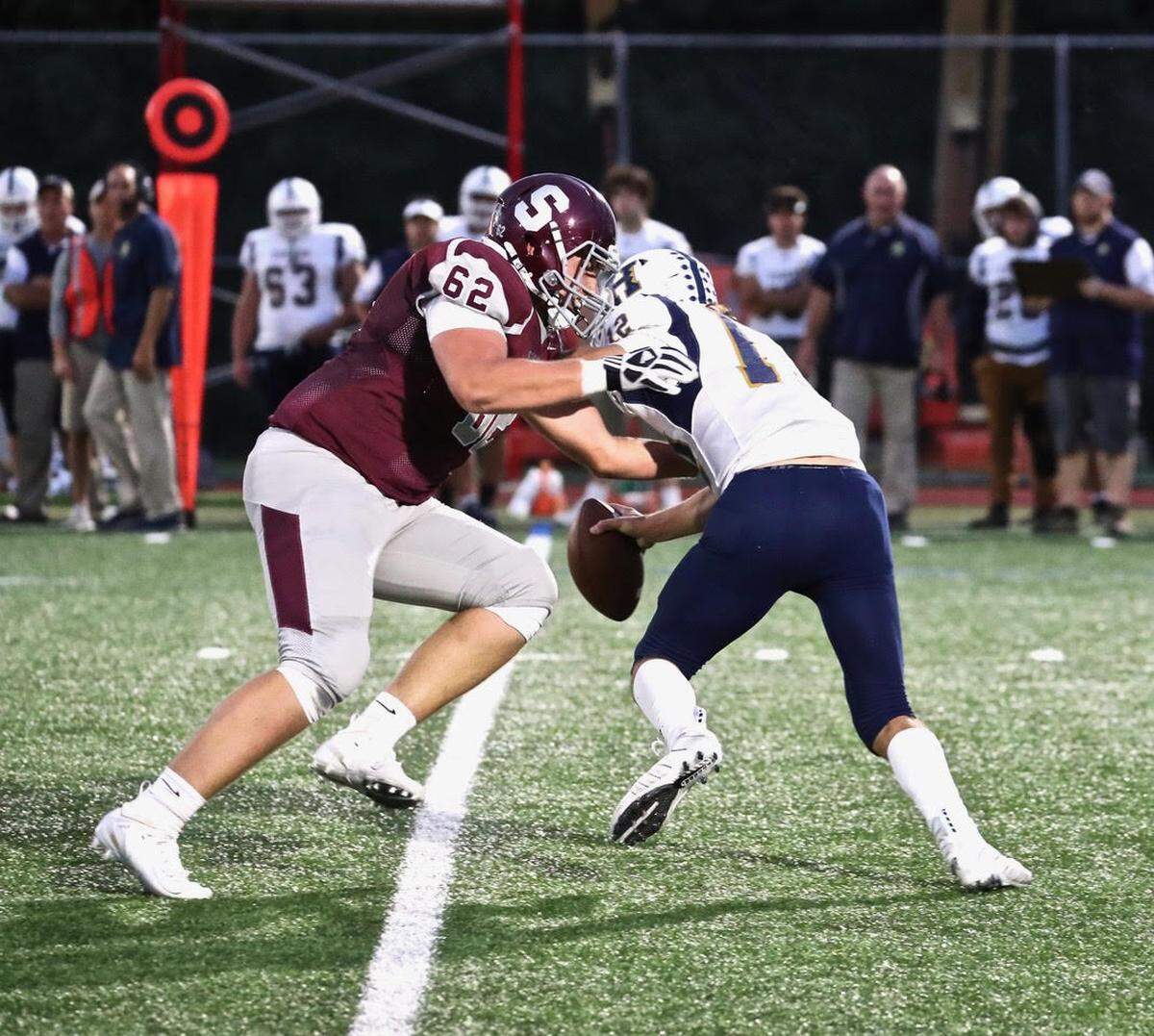 State College’s Sam Storll pressures Hollidaysburg QB Bryce Martellacci on Friday at the South Track.