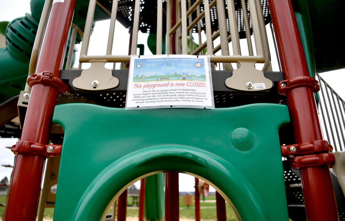 A sign reading that the playground is now closed hangs off the jungle gym at Tudek Park on Monday, March 30, 2020.