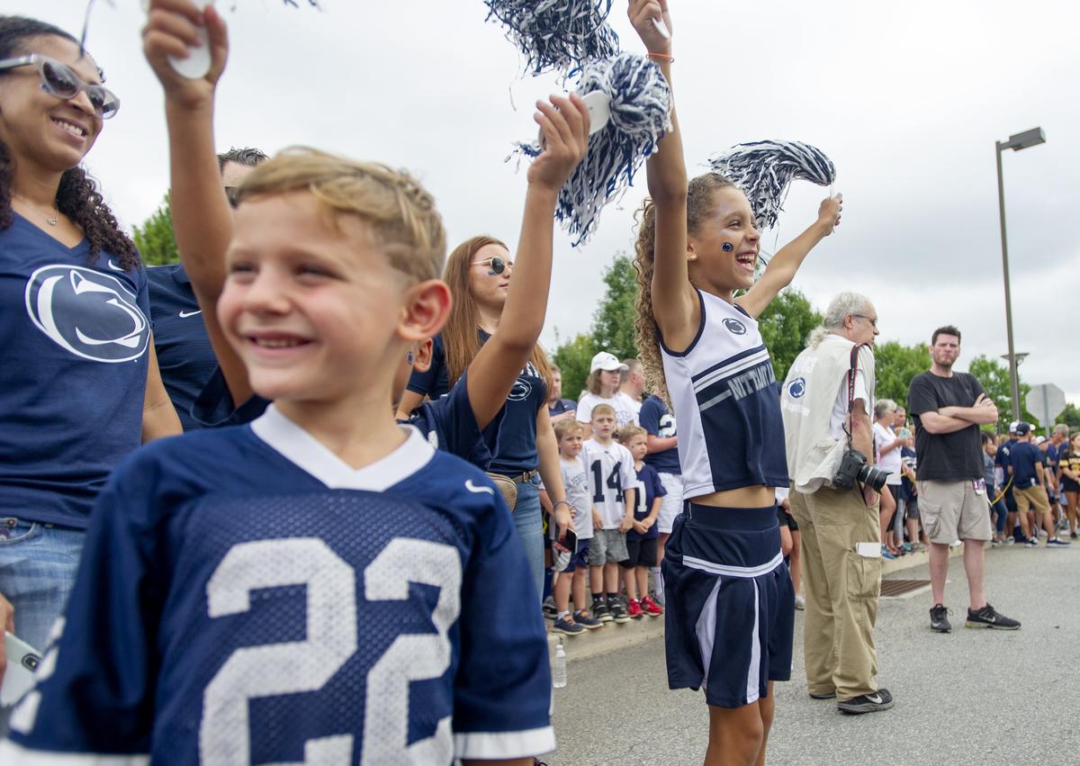 Owen Rogalski, 7, laughs as his cousin Addy Rosenberg, 6, cheers waiting for the Penn State football team to arrive for the season opener against Appalachian State at Beaver Stadium on Saturday, September 1, 2018.