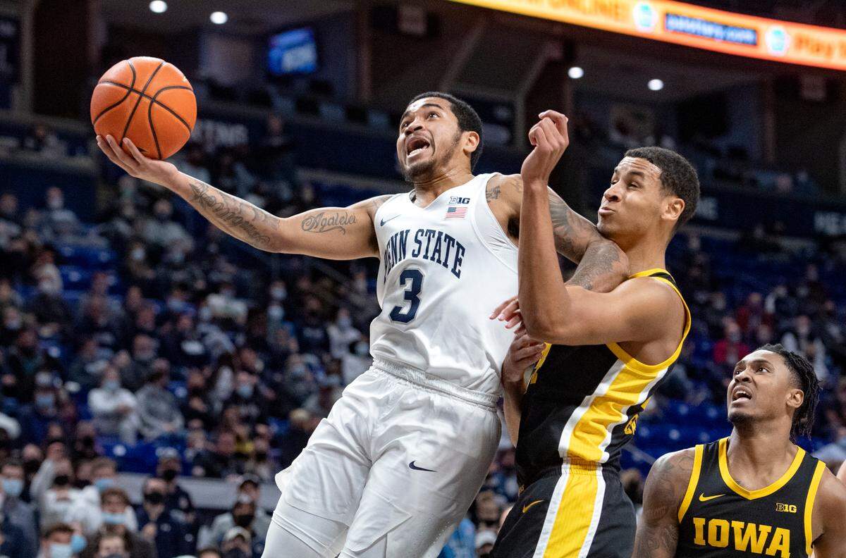 Penn State’s Sam Sessoms goes in for a basket around Iowa’s Kris Murray during the game on Monday, Jan. 31, 2022.
