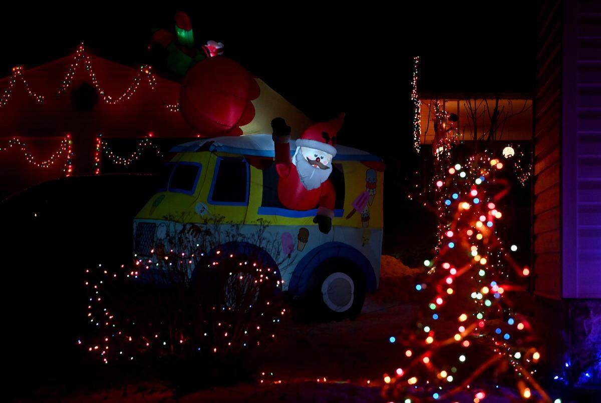 Santa in an ice cream truck, along with other inflatables and lights, fill the yard Fran Gray’s home in Rush Township on Wednesday, Dec. 21, 2022.