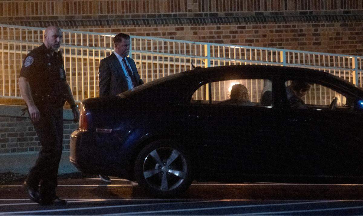 Police escort Gavin McInnes to a car to leave the Thomas Building after the “Stand Back & Stand By” event was canceled on Monday, Oct. 24, 2022.