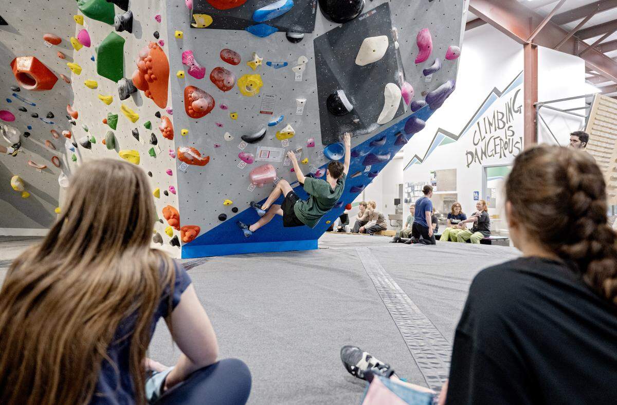 Friends encourage each other as they boulder at Climb Nittany on Thursday, May 14, 2026. 
