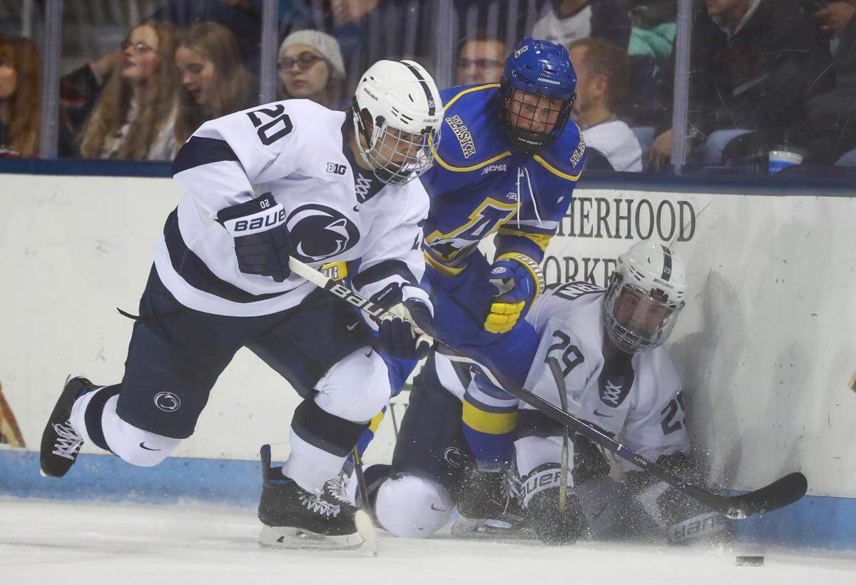 Penn State forward Aarne Talvitie (20) gets the puck away from Alaska Fairbanks defensiveman Garrett Pyke, center, and fellow teammate Connor MacEachern (29) during an NCAA hockey game on Thursday, Oct. 17, 2019 in University Park.