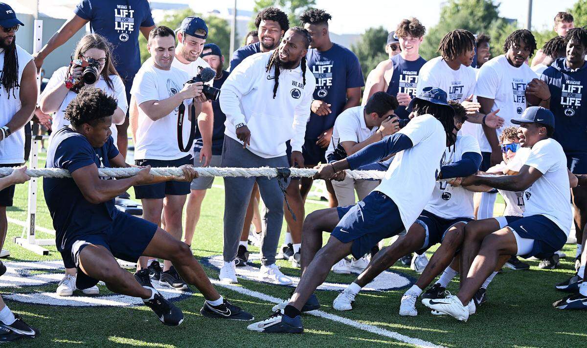 Penn State football players compete in a tug-of-war to finish of the Nittany Lions annual Lift For Life event at University Park Thursday, June 30, 2022.