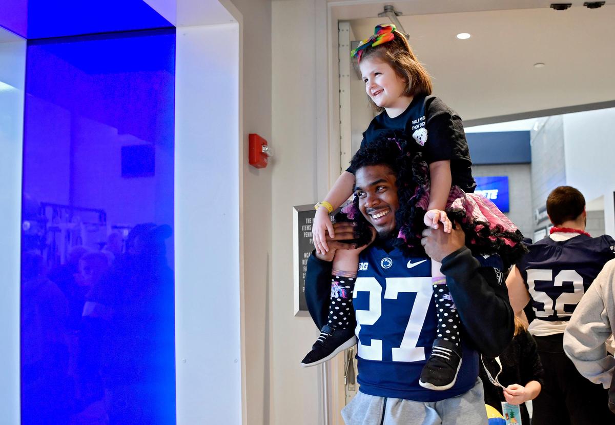 Penn State’s Aeneas Hawkins’ gives a youngster a ride on his shoulders at the Lasch Building on Saturday, Feb. 22, 2020.