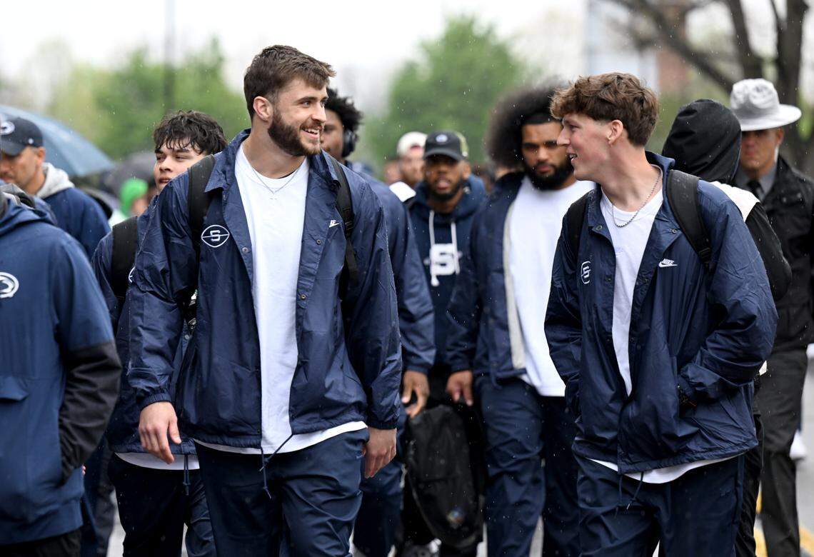 Penn State football players laugh together as they arrive at Beaver Stadium for the Blue-White Practice on Saturday, April 25, 2026.  