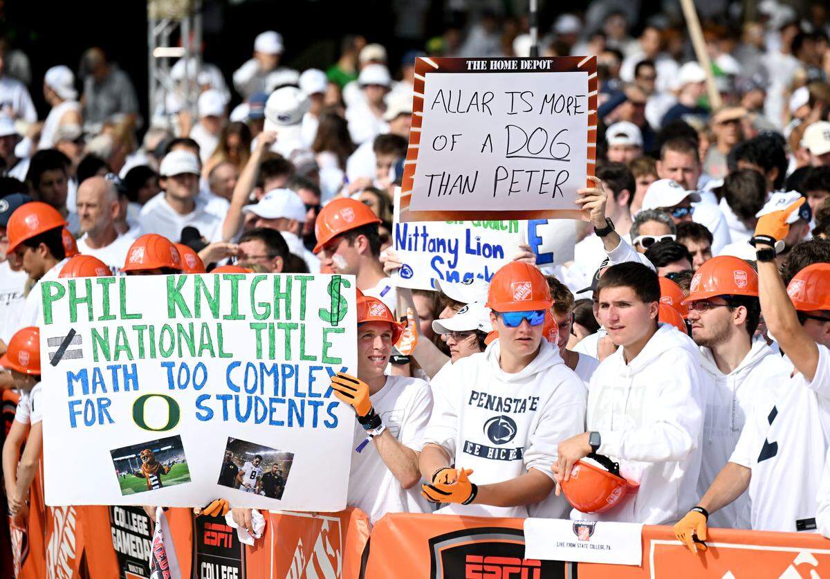 Fans hold up signs during ESPN’s College GameDay as it films at Penn State on Saturday, Sept. 27, 2025.  
