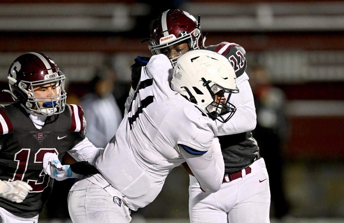 State College’s John Scott stops McDowell’s Christian Santiago during the game on Friday, Nov. 18, 2022.