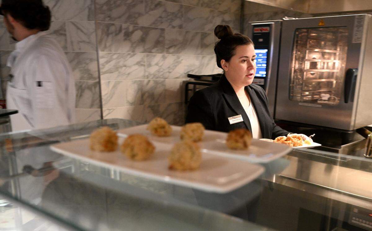 Sara Katonka helps get appetizers ready to serve during the Amalfi Dream themed dinner at Cafe Laura on Wednesday, March 1, 2023.