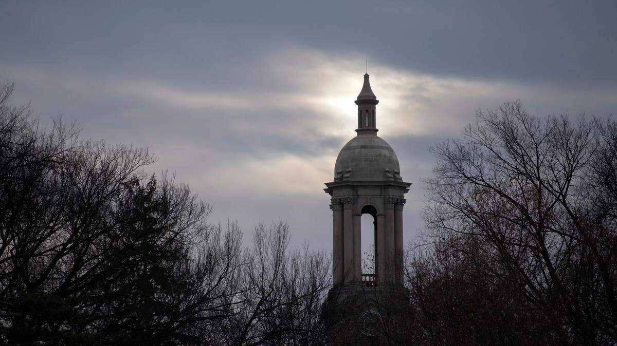 The sun illuminates the Old Main bell tower on the Penn State campus on Friday, Dec. 17, 2021.
