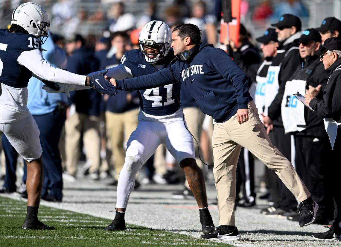 Penn State defensive coordinator Manny Diaz highf-ives players after a play during the game against Rutgers on Saturday, Nov. 18, 2023.  
