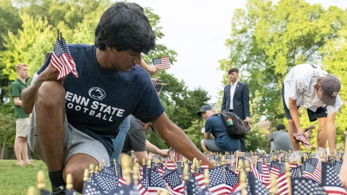 Penn State students gathered at Old Main on Thursday to place 2,997 American flags on the lawn, one to honor each of victim of the terrorist attacks on Sept. 11, 2001.