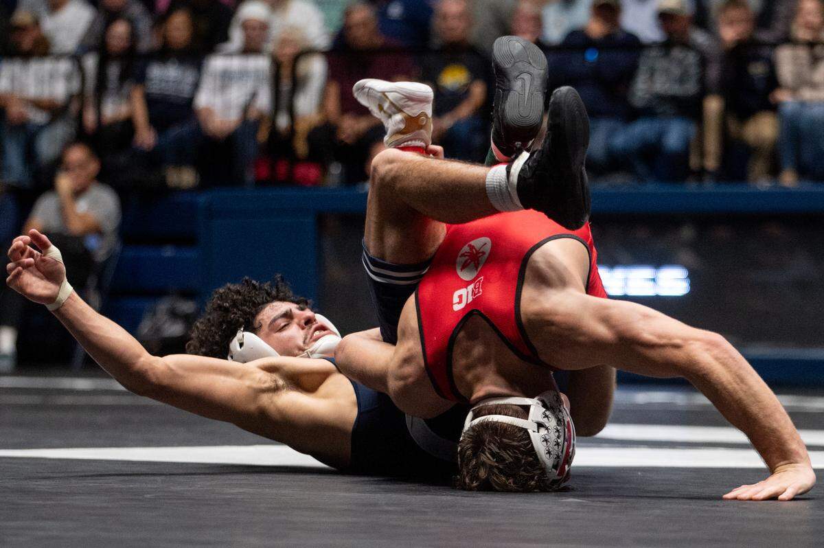 Beau Bartlett, left, wrestles Jesse Mendez, right, in a 141-pound bout during the NWCA All-Star Classic at Rec Hall on Saturday, Nov. 16, 2024. Mendez won the bout 4-1.