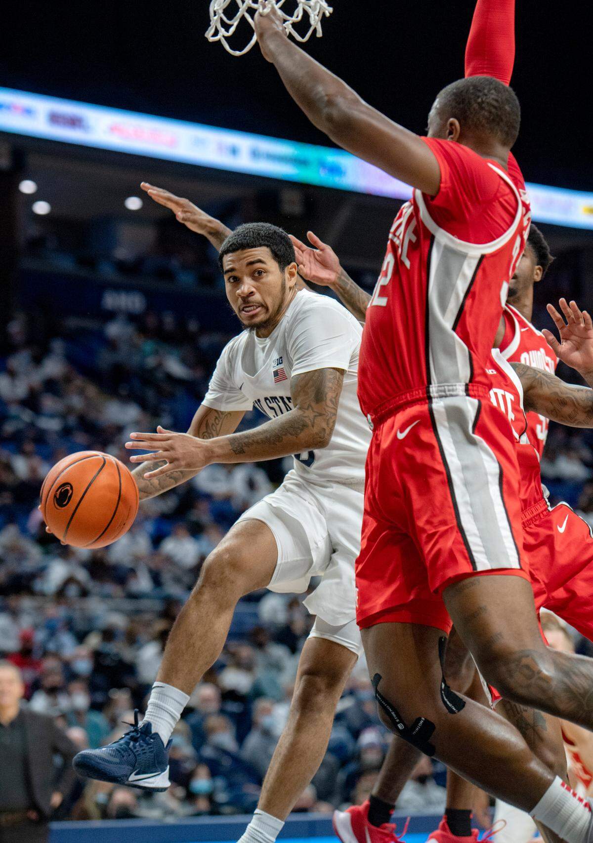 Penn State’s Sam Sessoms tries to pass to a teammate after getting blocked at the net by Ohio State defedners during the game on Sunday, Dec. 5, 2021.