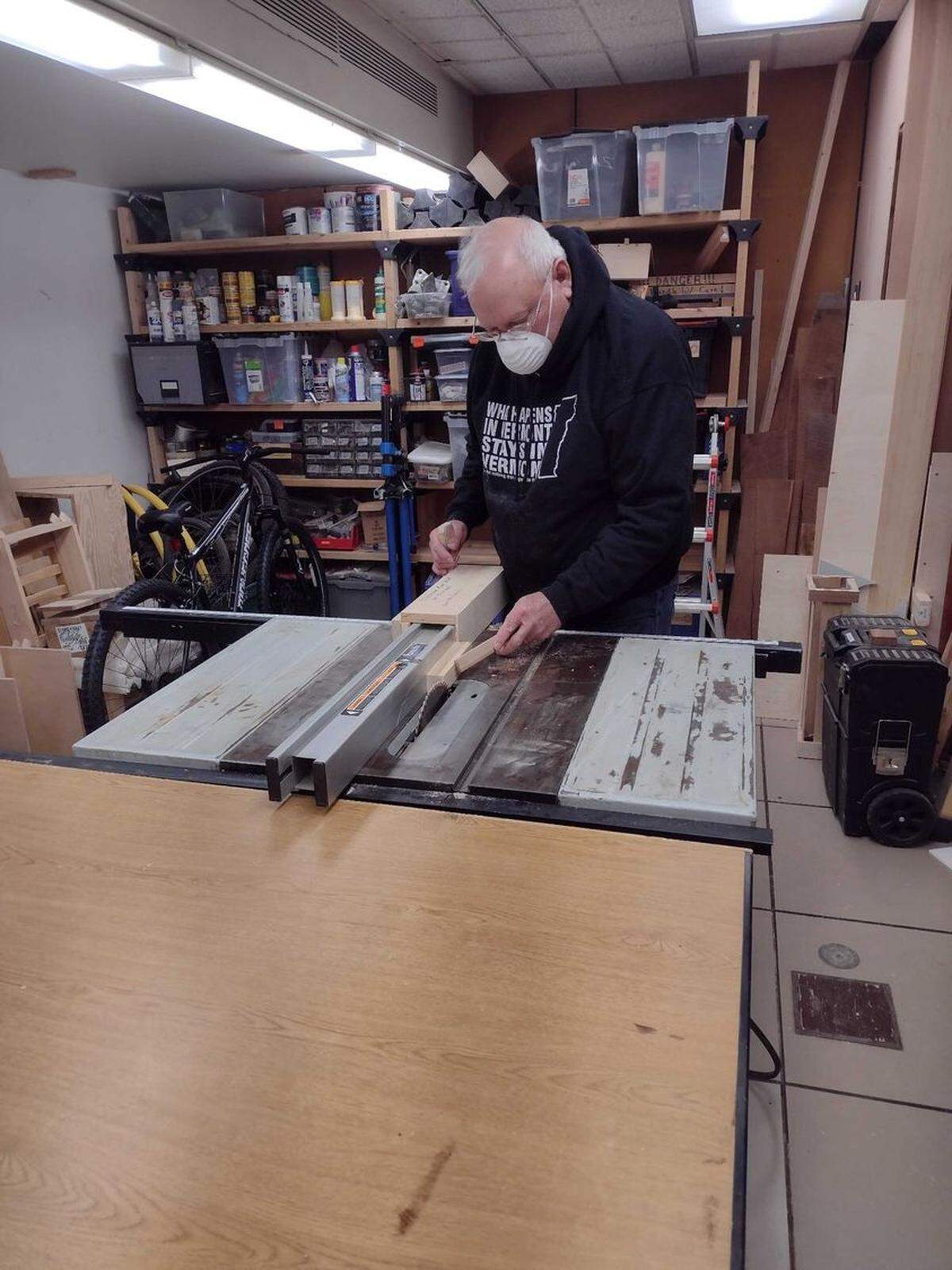 A Make Space member uses a table saw for a project.
