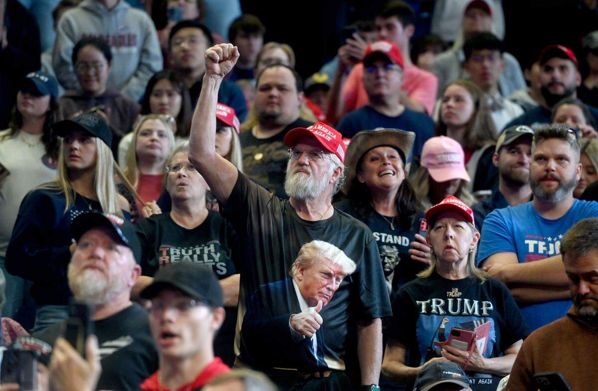 Donald Trump supporters cheer as they wait for the former president to take the stage for his rally at the Bryce Jordan Center on Saturday, Oct. 26, 2024.