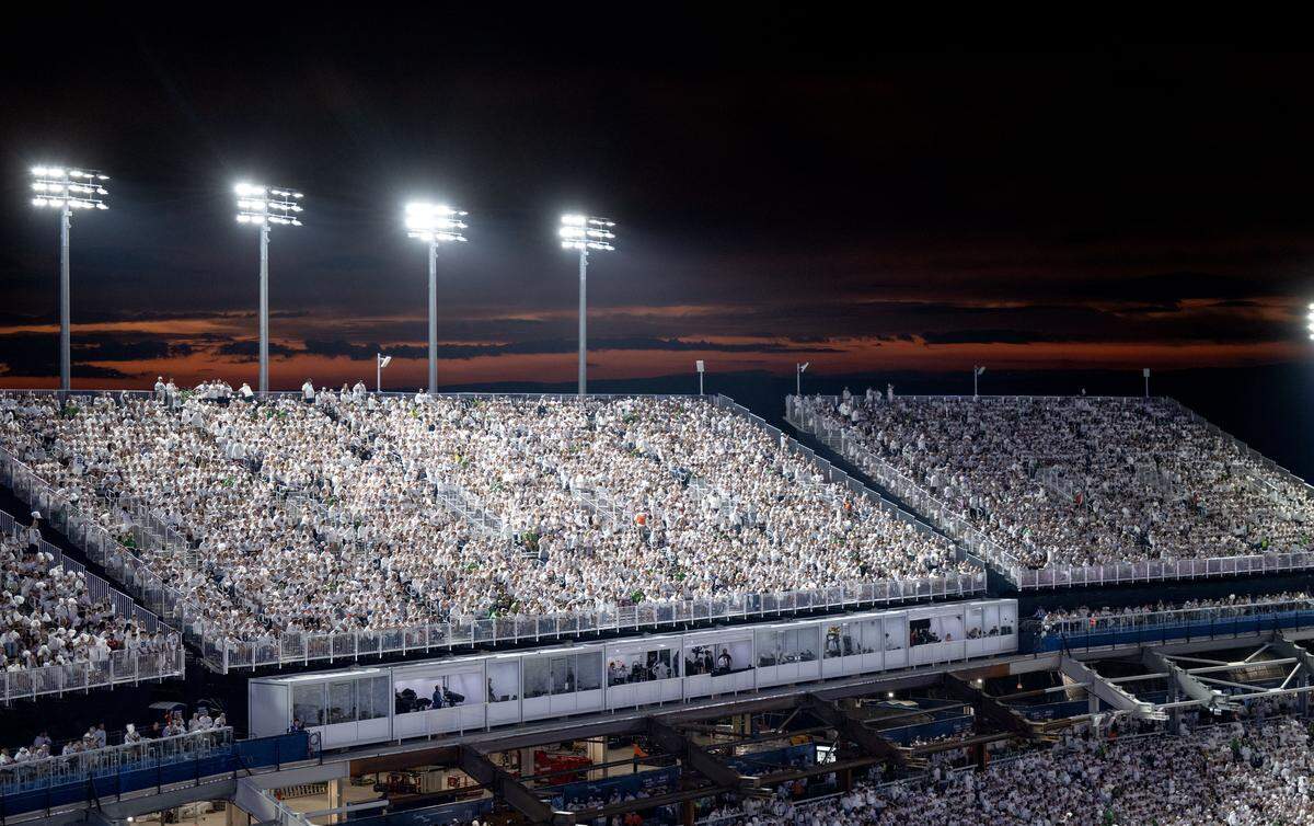 The sun sets behind the temporary stands on the west side of Beaver Stadium before the White Out Penn State football game against Oregon on Saturday, Sept. 27, 2025.  