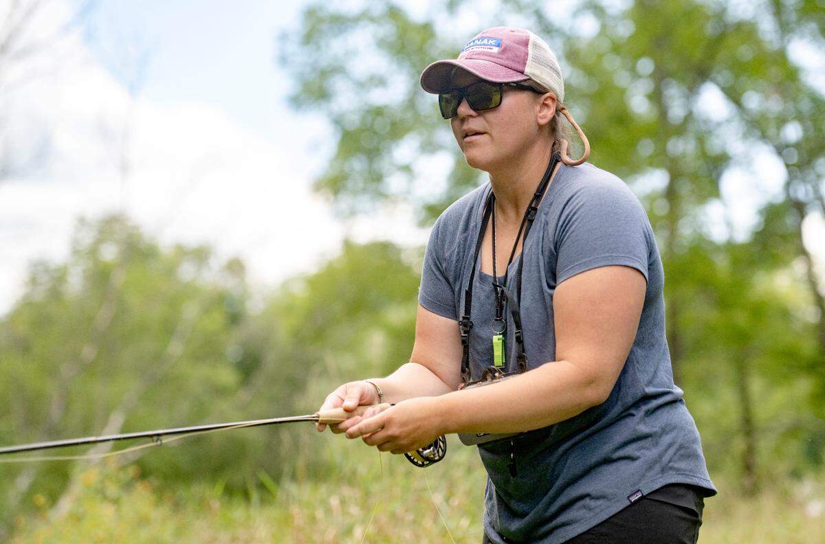 Tess Weigand picks a fly as she dry fly fishes along a section of Pine Creek on Wednesday, Aug. 24, 2022.