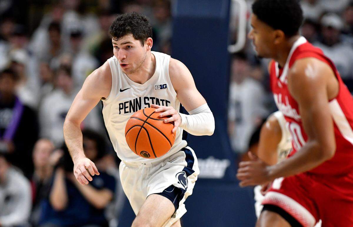 Penn State’s Andrew Funk dribbles down the court with the ball ahead of Nebraska defenders during the game on Saturday, Jan. 21, 2023.