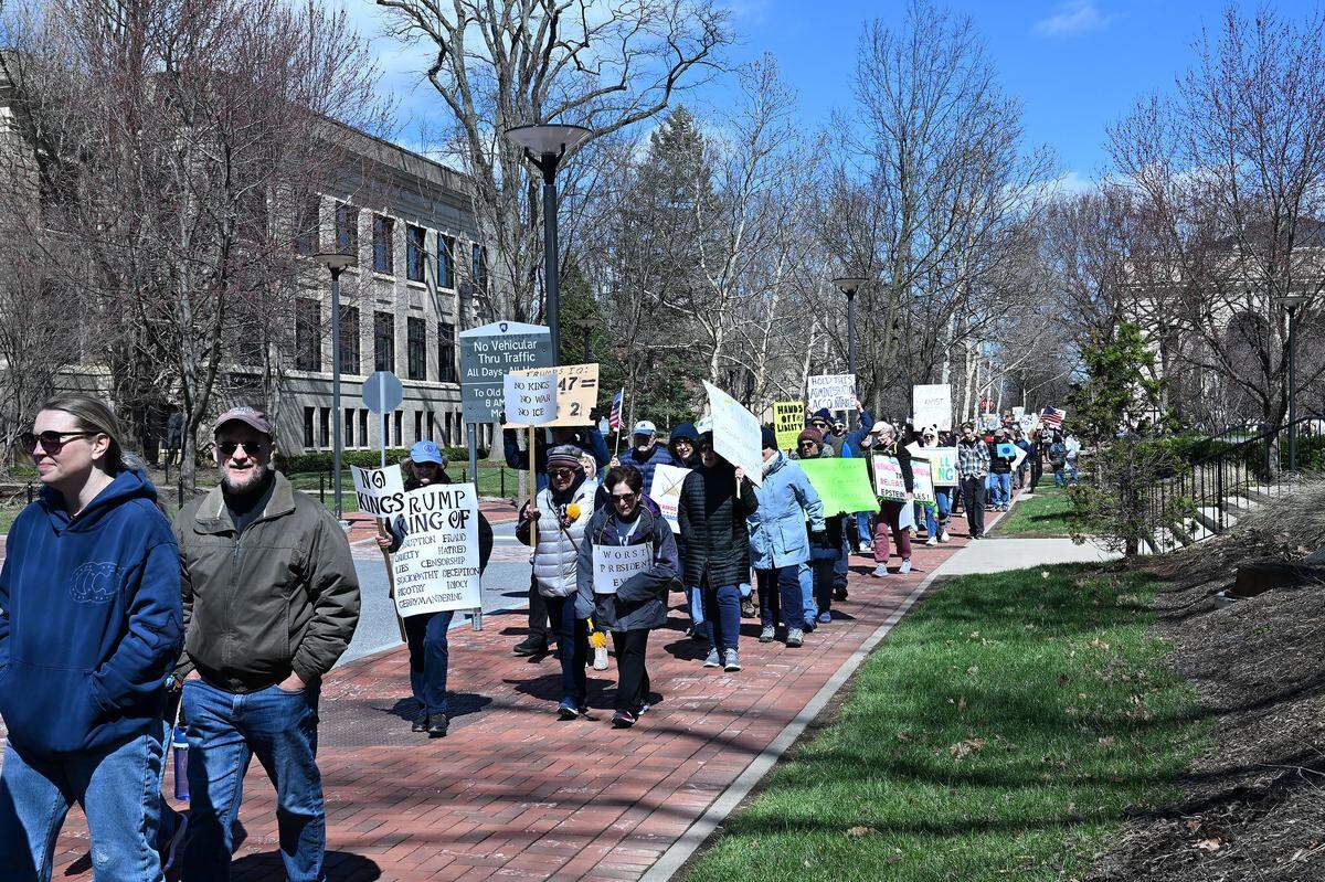 Protesters marched through the Penn State campus following a rally as part of the No Kings anti-Trump rally on Saturday.