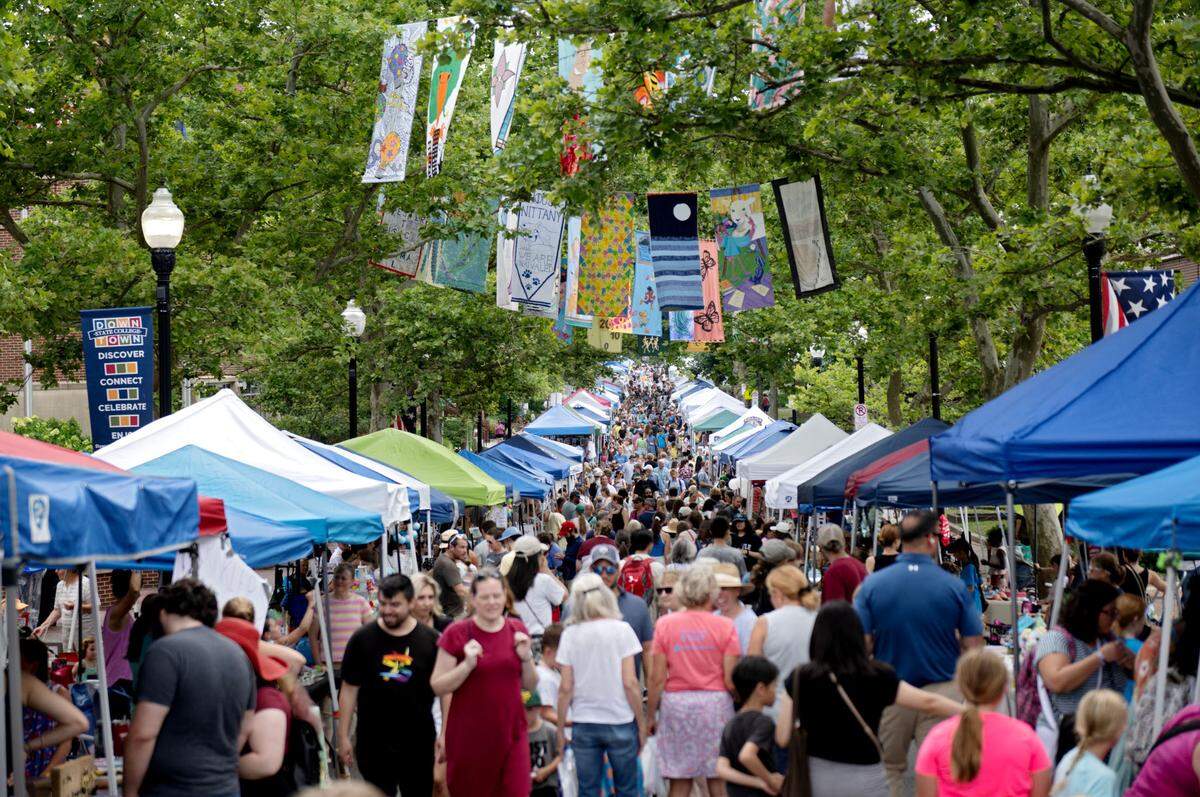 Hundreds of people walk along the young artists booths at the Central Pennsylvania Festival of the Arts Children and Youth sidewalk sale on Wednesday, July 10, 2024.
