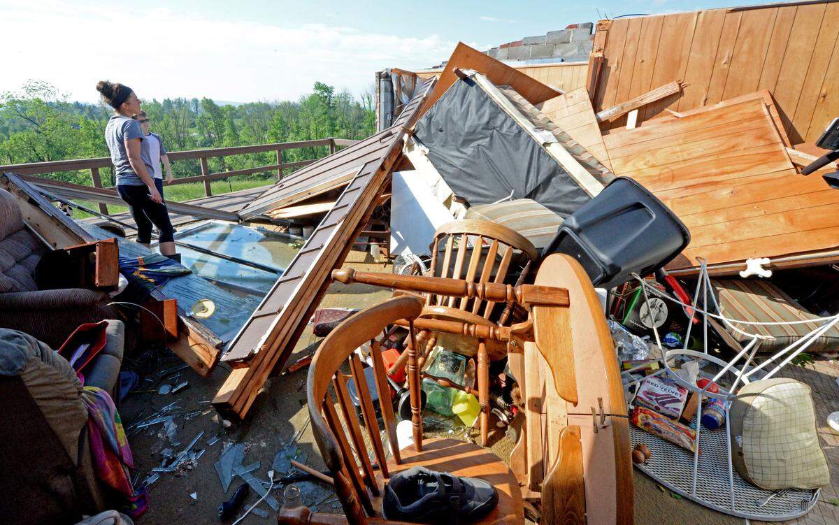 Erin Grubb looks though a neighbor’s home on Kline Road in Denver, Pa., Monday, May 20, 2019. The roof was completely blown off the house in a storm that moved though the area at about 8:00 Sunday evening. (Blaine Shahan/LNP Media Group via AP) (Blaine Shahan/LNP Media Group via AP)