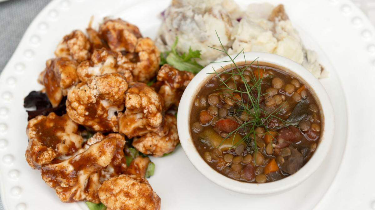BBQ cauliflower made with a date-sweetened barbecue sauce, along with a mushroom gumbo and potato salad is pictured from Websters Bookstore Cafe on Wednesday, July 17, 2024.