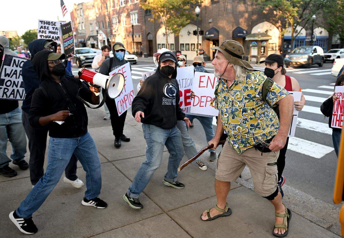 A man clashes with the crowd that had gathered for an anti-ICE protest on Thursday, Sept. 11, 2025.  
