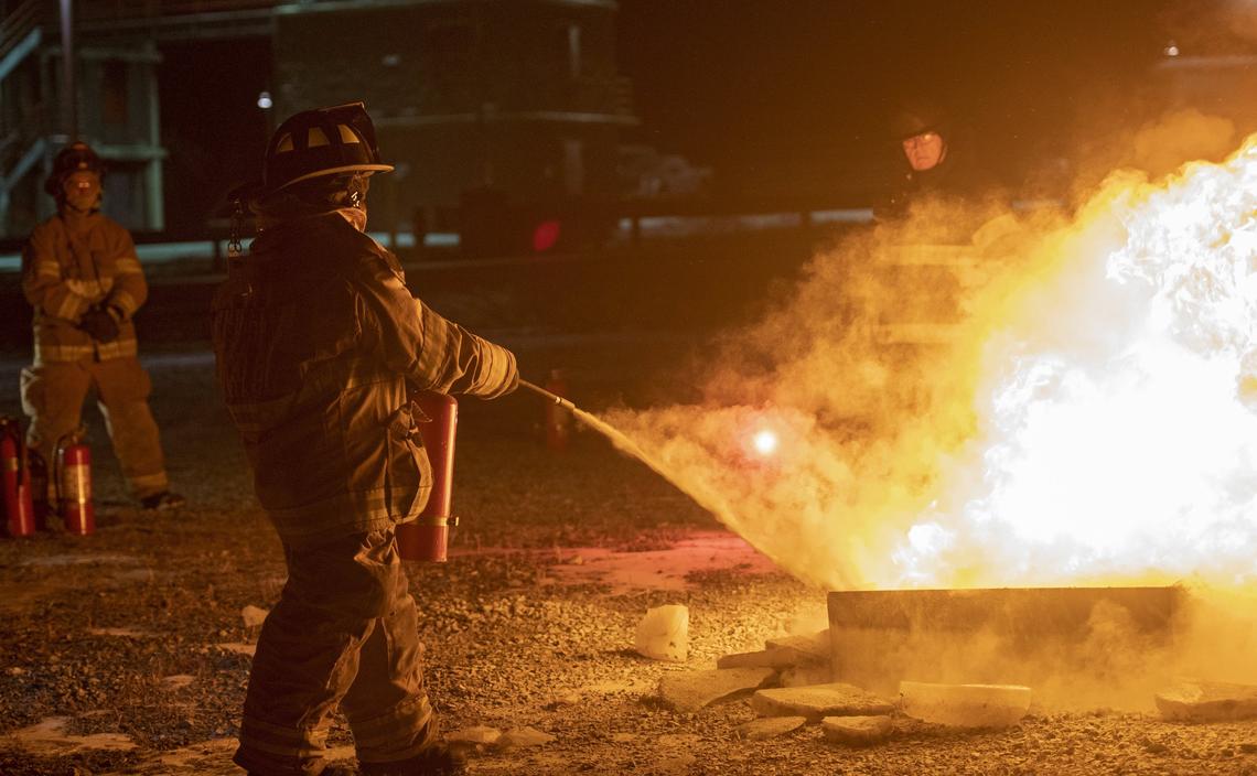 Carly Wojtaszek uses a fire extinguisher during a firefighting training class on Jan. 17 at the Centre County Public Safety Training Center.