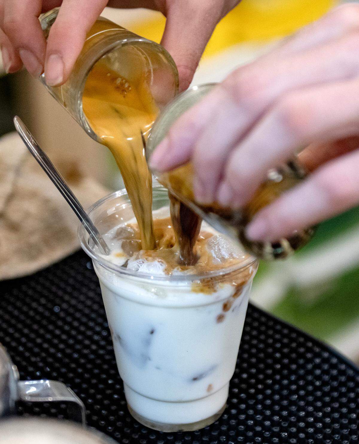 Tyler Wirtz makes an iced caramel latte at Shaky Hands Coffee Shop on Tuesday, June 10, 2025.