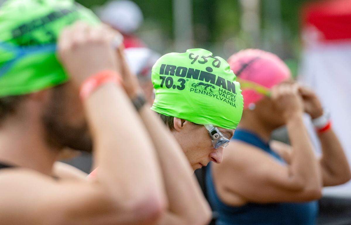 Athletes put on their googles and prepare for the 1.2 mile swim in Foster Joseph Sayers Lake at Bald Eagle State Park for the Ironman 70.3 Pennsylvania Happy Valley on Sunday, June 30, 2024.