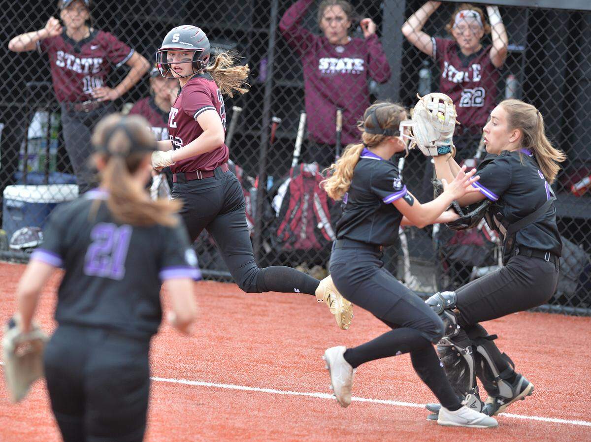 State College’s Olivia McTavish,left, looks back to see Mifflin County catcher Alaina Sharp pull in her tipped ball to make the last out of the game in the District 6 6A title championship game Wednesday, May 25, at St. Francis University.