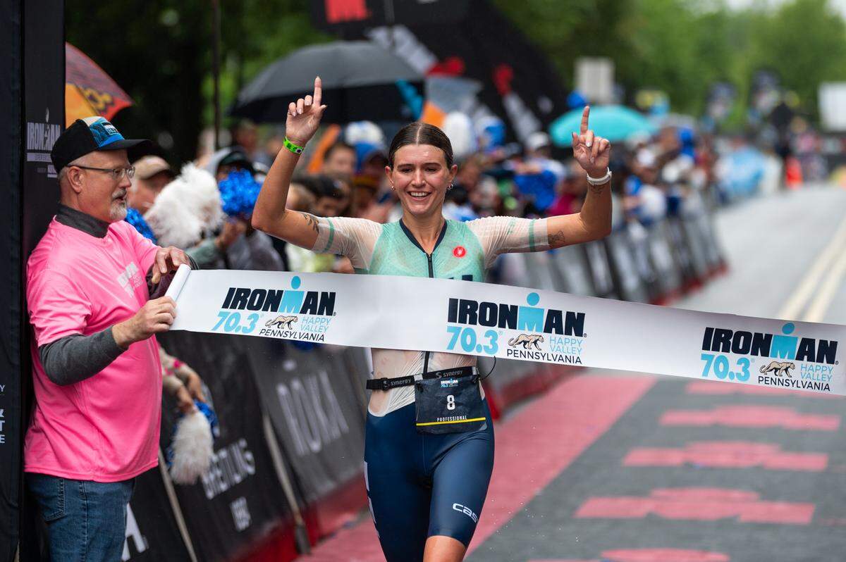 Lydia Russell, first-place finisher overall and in the women’s Pro group crosses the finish line at the Ironman 70.3 Happy Valley on Sunday, June 15, 2025 in University Park, Pa.