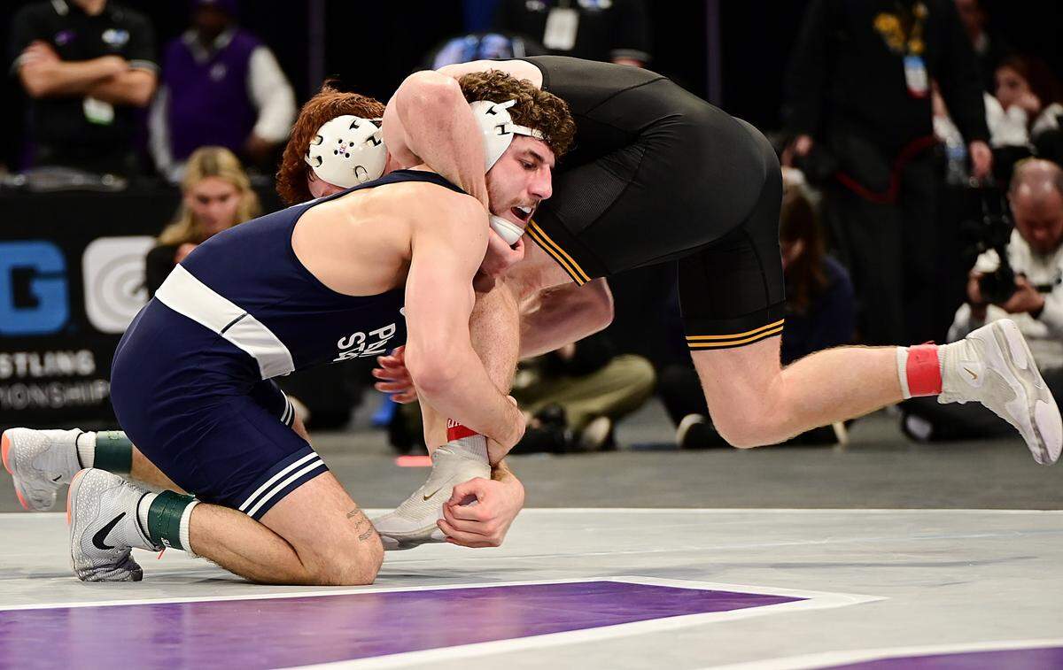 Penn State’s Mitchell Mesenbrink attempts to takedown Iowa’s Mikey Caliendo in their 165-pound finals match of the Big Ten championships on March 9 inside Welsh Ryan Arena in Evanston, Ill. Mesenbrink topped Caliendo, 4-1, for his second straight conference crown.
