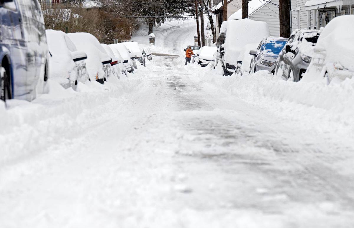 A person cleans their car off along West Logan Street in Bellefonte on Monday, Jan. 26, 2026.  