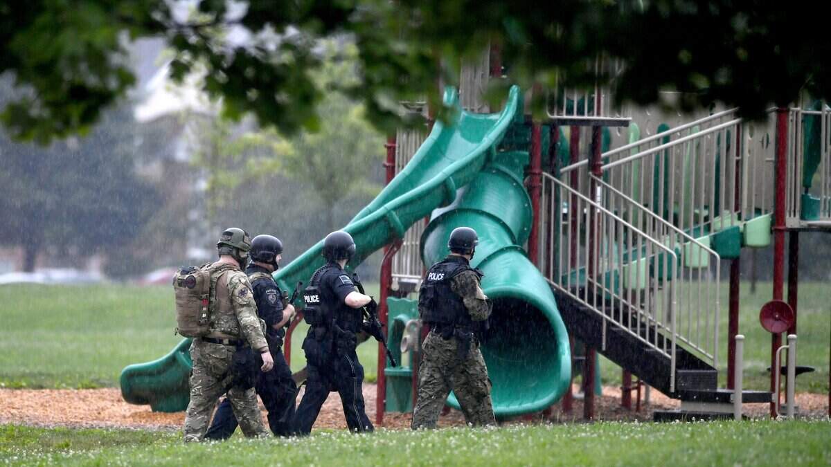 Members of the Centre County Tactical Response Team walk through Tudek Park in August 2017 as they look for the suspect who robbed SPE Federal Credit Union on Science Park Road.