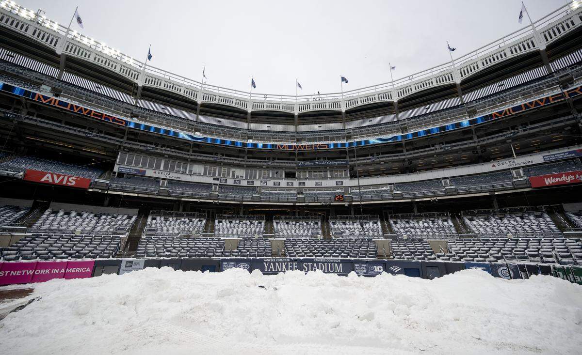 Snow is piled up by home plate in Yankee Stadium before the Pinstripe Bowl on Saturday, Dec. 27, 2025.  