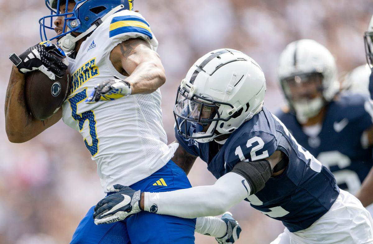Penn State cornerback Zion Tracy reaches for Delaware’s Joshua Youngblood during the game on Saturday, Sept. 9, 2023.