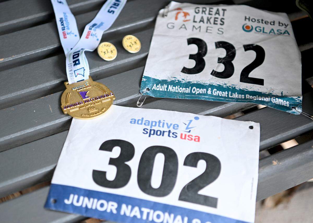 RJ Shirey has saved awards and athlete bibs from his time competing with Penn State Ability Athletics, now known as Adaptive Athletics.