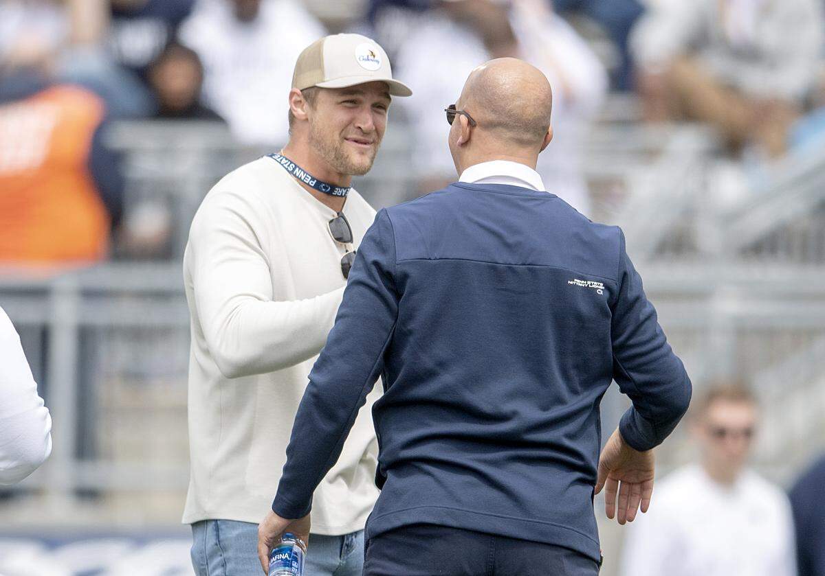 Former Penn State player and current Miami Dolphin Mike Gesicki greets Penn State football coach James Franklin before the Blue-White game on Saturday, April 23, 2022.