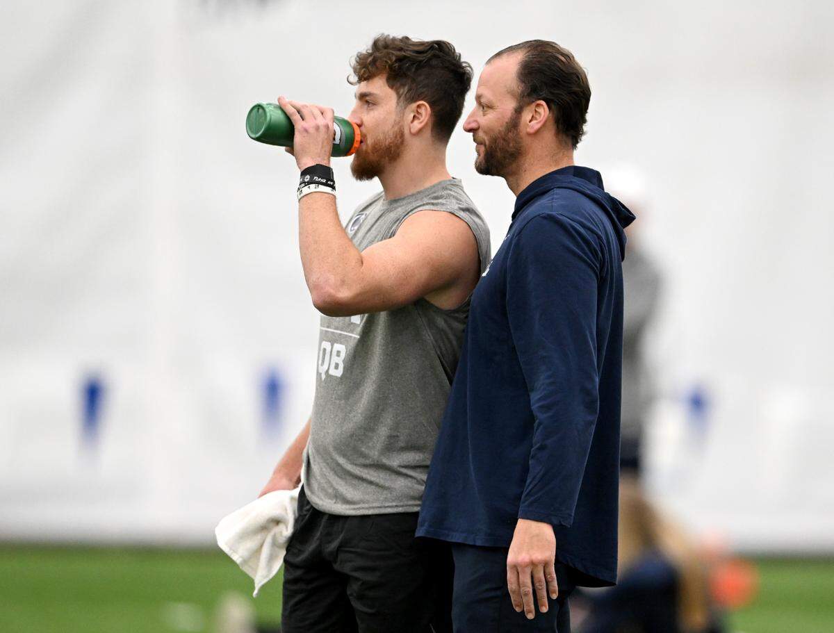 Quarterback Sean Clifford listens to Penn State offensive coordinator Mike Yurcich as he takes a break from throwing passes during Penn State football’s Pro Day on Friday, March 24, 2023.