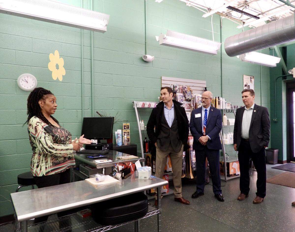 Vivian Y. Black, owner of S’Hair-Eng Styling Salon, talks about owning a small business in downtown State College. To the right are State College Mayor Ezra Nanes, Centre County Commissioner Mark Higgins and Rep. Paul Takac.