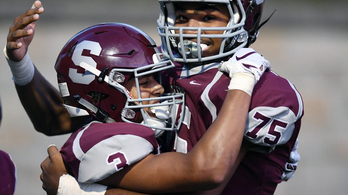 State College wide receiver Keaton Ellis celebrates scoring a touchdown with offensive tackle James Pone during Friday’s game against Mifflin County.