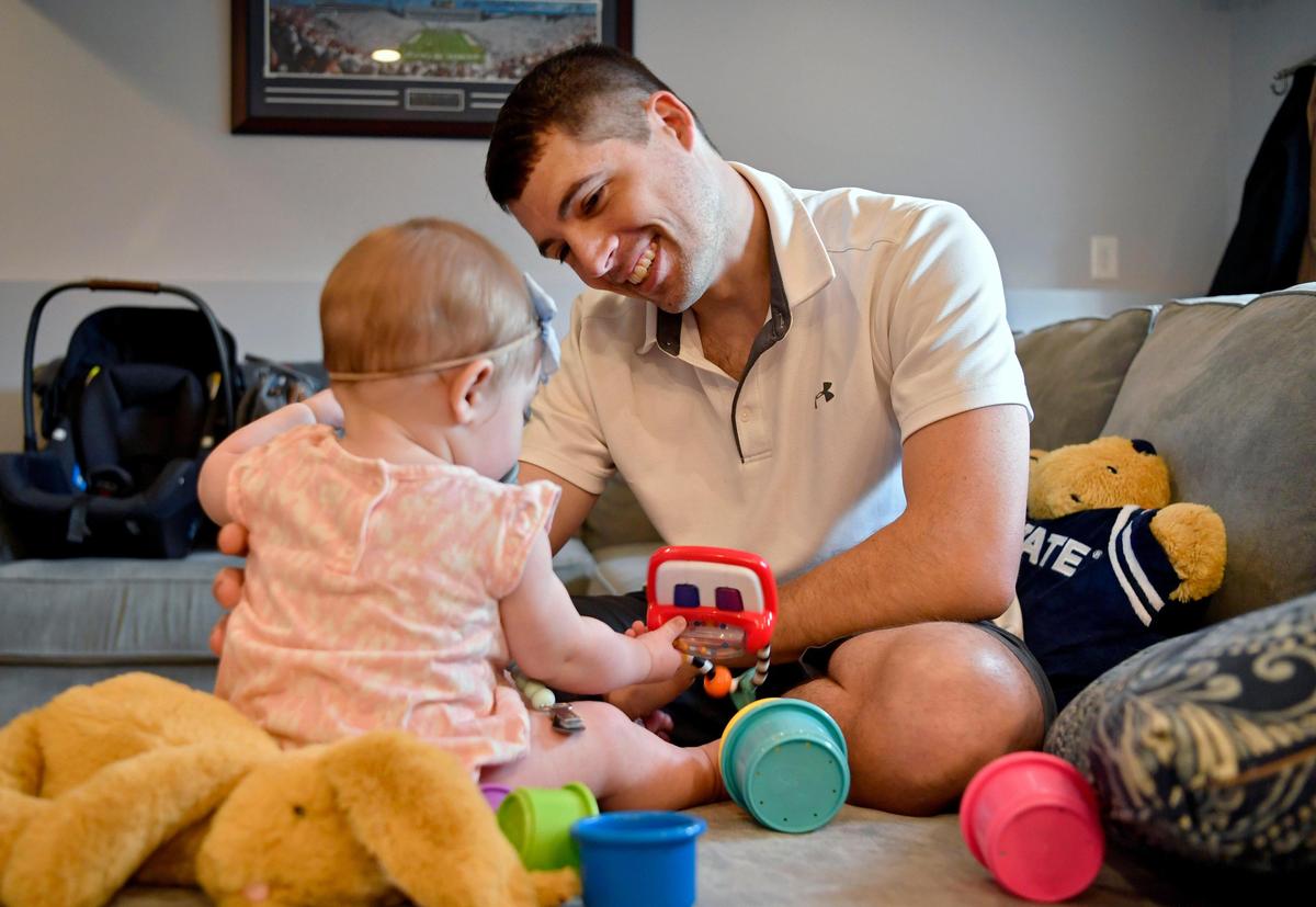 Dan Lewis plays with his daughter Hadley in their home on Wednesday, June 3, 2020. Lewis tested positive for COVID-19 in April and spent two weeks quarantined in their basement, unable to play with his young daughter.