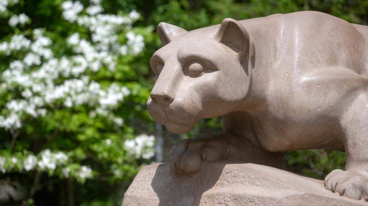 Flowers bloom around the Nittany Lion shrine on the Penn State campus on May 11, 2023.