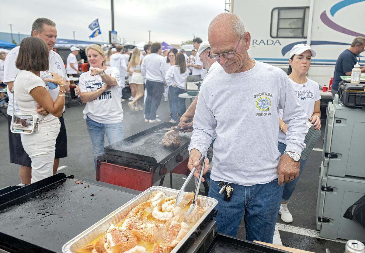 A tailgate cooks up lobster tails before the Penn State and Oregon football game at Beaver Stadium on Saturday, Sept. 27, 2025.  